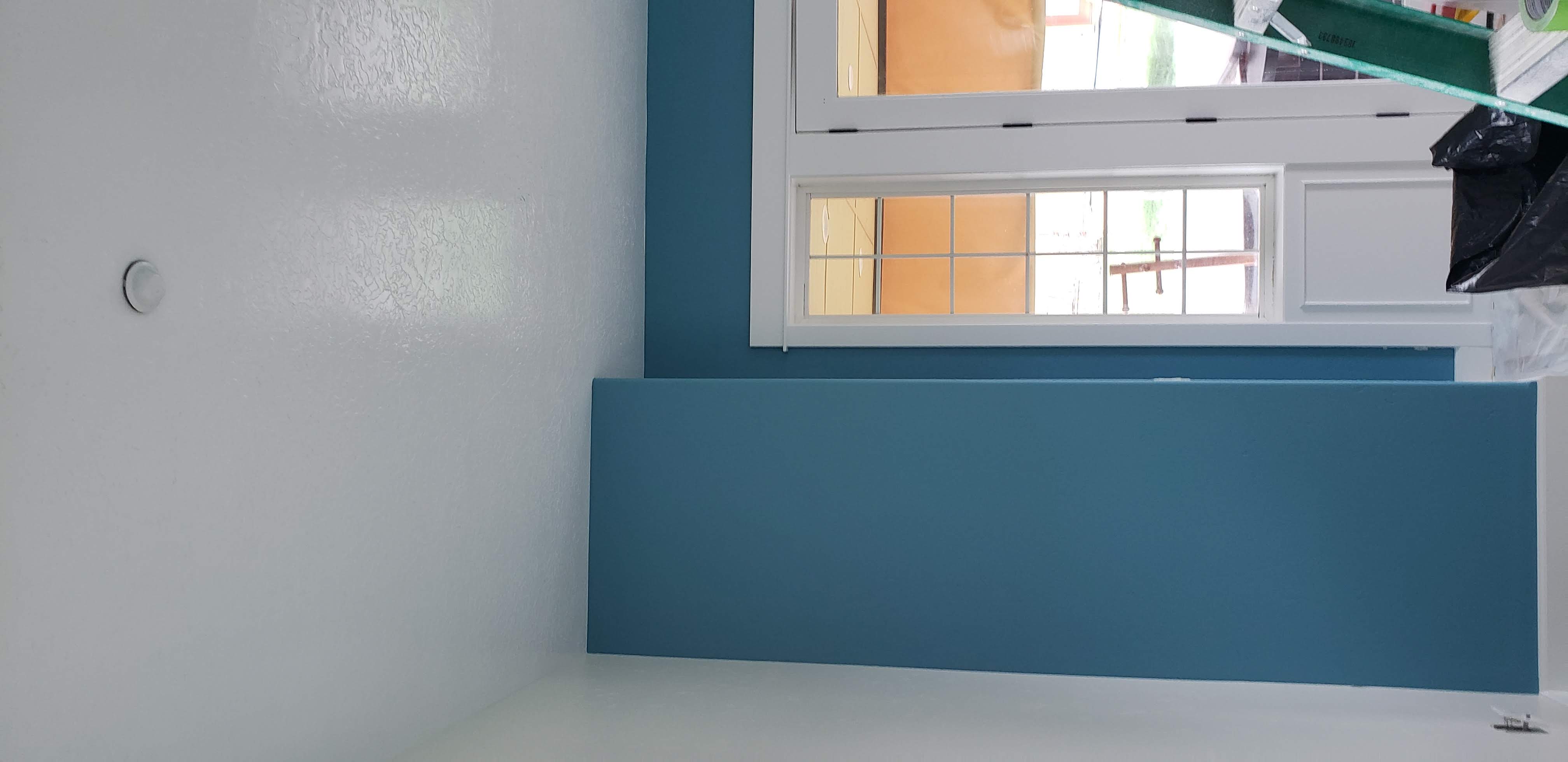 Finished blue accent walls, white trim, and a painted ceiling